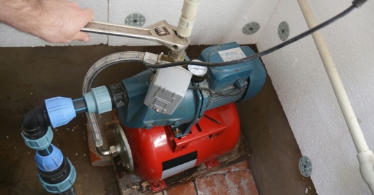 Sump pump getting worked on in a basement